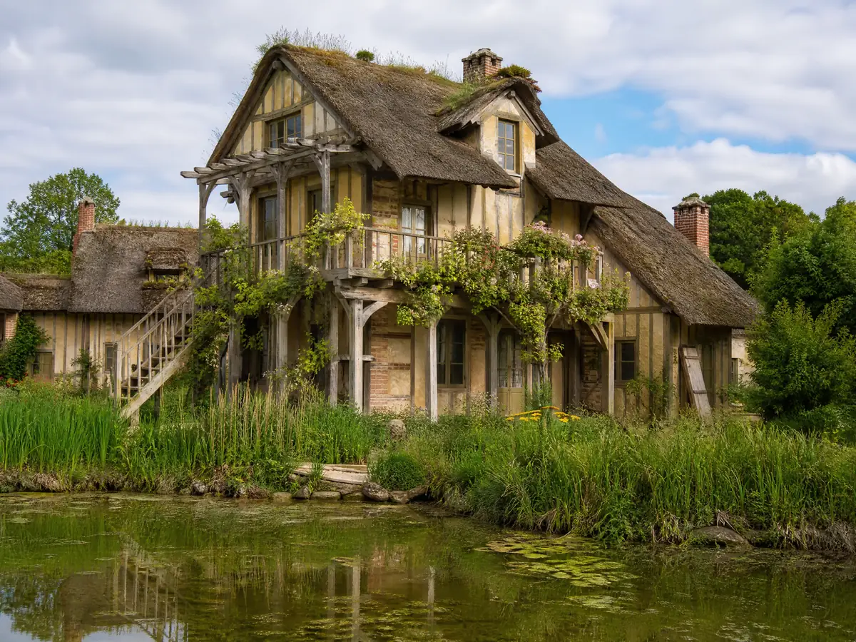 A Hamlet farmhouse with a wooden balcony and a thatched roof